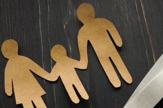 cutout family with scissors representing parental alienation