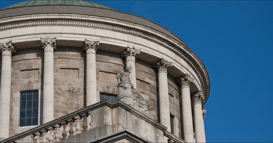 The Four Courts building, located on Inns Quay in Dublin. Blue sky in the background.